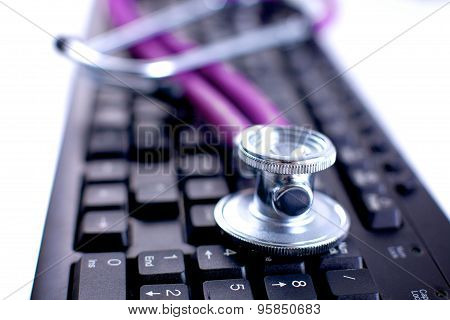 Violet stethoscope on a laptop computer