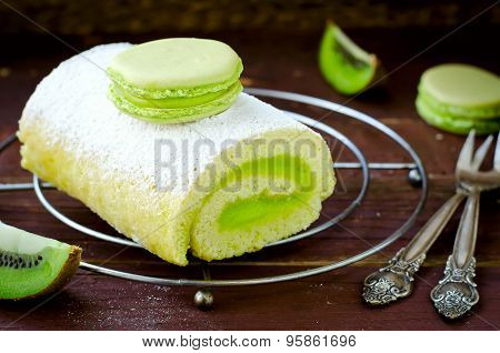 Roll cake with kiwi cream decorated macarons