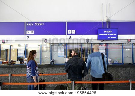 WARSAW, POLAND - SATURDAY, JUNE 6, 2015: Passengers on line to purchase tickets inside the main Polrail, PKP, train station in Warsaw.  