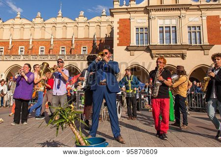KRAKOW, POLAND - JUL 11, 2015: Participants at the annually (July 9-12) 28th International Festival of Street Theatres - Orchestre International du Vetex (Belgium/France) in the Main Square of Krakow.