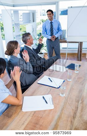 Business people applauding during a meeting in the office