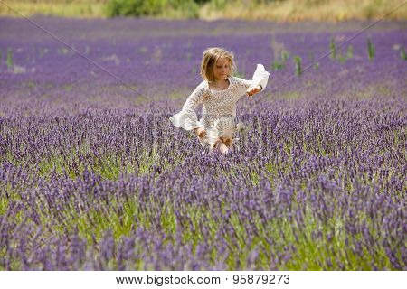Beautiful blonde girl runs through a lavender field