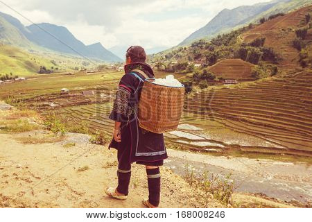 SAPA, VIETNAM - OCTOBER 29, 2012: Hmong women sell souvenirs in Sapa. The Hmongs are known for their colorful clothes and silver jewelry. Hmong women have various clothes colours and style