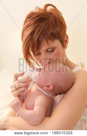 Sick baby of 7 weeks old getting treatment with nebuliser or aerosol