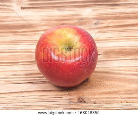 Ripe organic kanzi apple on vintage wooden tray
