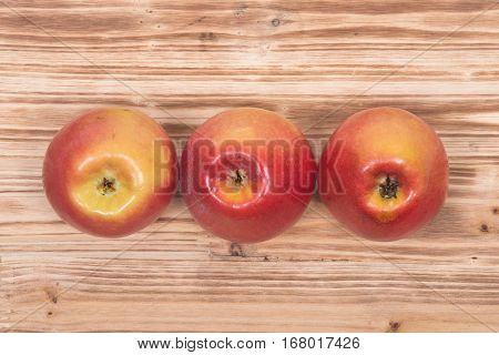 Ripe organic kanzi apple on vintage wooden tray