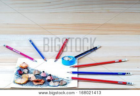 Pencil sharpener shavings on the white paper. Back to school. Copy space.