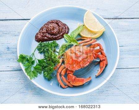 Seafood dish - cooked crab with lemon and herbs.