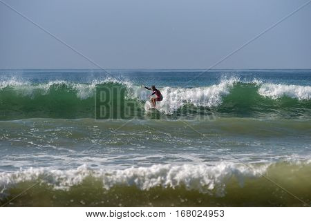 Weligama, Sri Lanka - January 09 2017: Unidentified Man Surfing On A Large Wave On Weligama Beach On