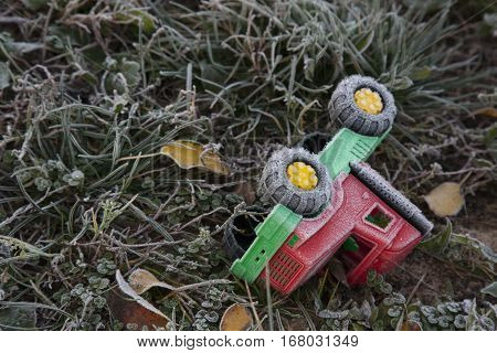 Belarus, Minsk - October 13, 2016 / Autumn morning on the playground toy fell into the grass fallen leaves frost on the grass frost on a toy frozen ground.