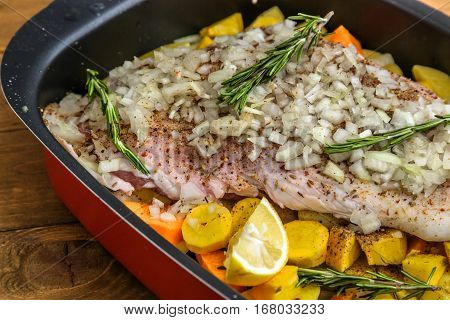 Raw Lamb Shank With Roots And Onion Ready For Frying On A Rustic Wooden Board. Close View