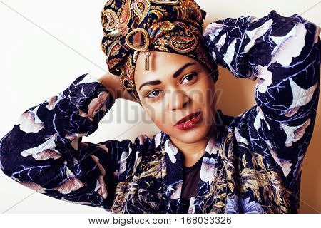 beauty bright african woman with creative make up, shawl on head like cubian closeup smiling, cheerful tan , lifestyle people concept close up