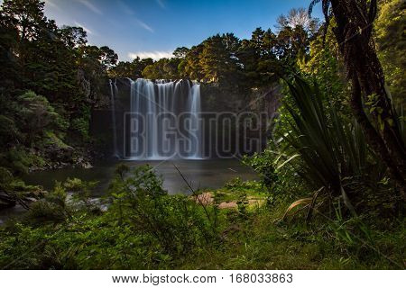 View of Rainbow Falls Kerikeri New Zealand from Track along River Surrounded by Bush Horizontal