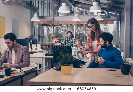 Young Woman Showing Diagrama Of Growth To Her Colleague