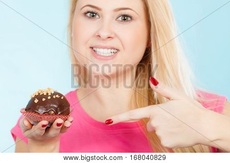 Woman Holding Chocolate Cupcake About To Bite