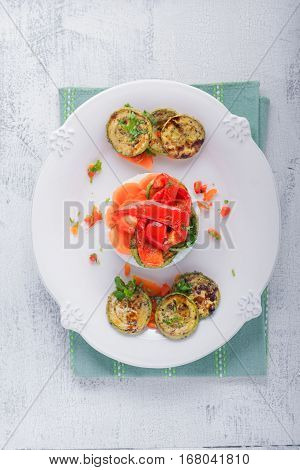 Rice timbale with fried zucchini, peppers and carrots