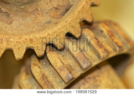 A set of rusted gears meshing together