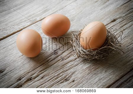 Chicken eggs on old wooden table background