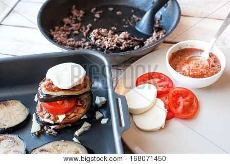 Ingredients for cooking Parmigiana di melanzane: baked eggplant - italy, sicily cousine. On the wooden table.