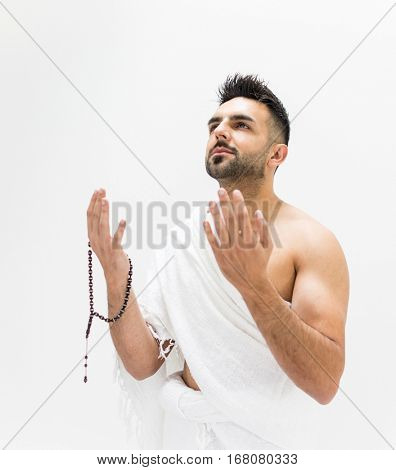 Muslim man posing as ready for Hajj visiting Kaaba in Mecca