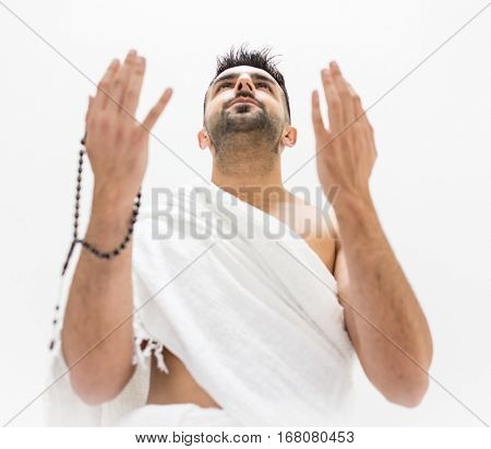 Muslim man posing as ready for Hajj visiting Kaaba in Mecca