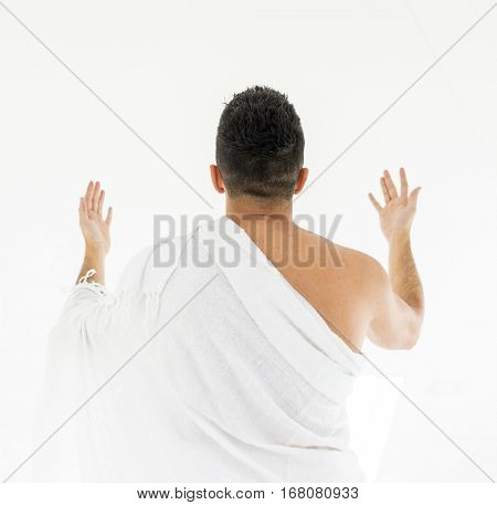 Muslim man posing as ready for Hajj visiting Kaaba in Mecca