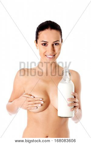 Nude woman is holding a ewer of milk. Spa concept.