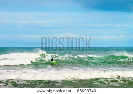 Adelaide Australia - August 14 2016: Surfer sliding the wave at Middleton Beach on a day. Middleton beach is one of the most famous places for surfing in South Australia