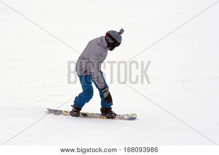 Man in sportswear snowboarding and are going to the mountains in winter.