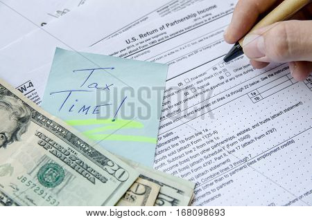 man filling Tax forms 1065 close up