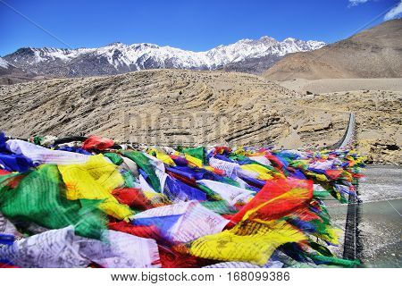 Suspension bridge between Lower Mustang and Upper Mustang with lot of colorful buddhist praying flags