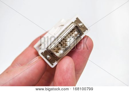 Hand holding a monitor plug DVI close up