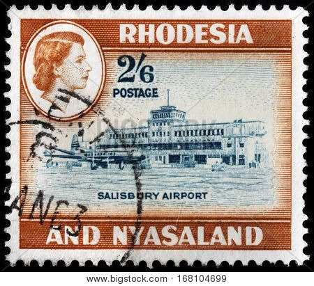 LUGA RUSSIA - SEPTEMBER 18 2015: A stamp printed by RHODESIA AND NYASALAND shows image portrait of Queen Elizabeth II against view of Salisbury Airport circa 1959