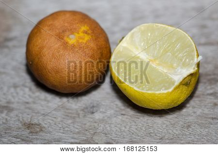 Lemon ripe withered unappetizing. Brown was placed on the wooden floor.