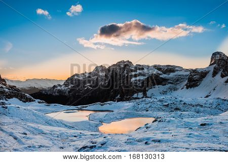 Snow and mountain lake Lago dei Piani near Drei Zinnen or The cime, Italy Alps Dolomites