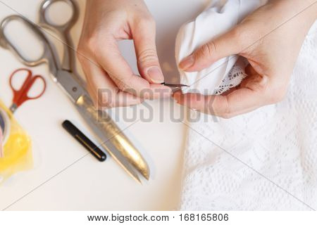 Woman unpick fabric on table