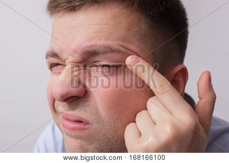Young Man Squinting, Trying To Review The Information Closer. Vision Problems.