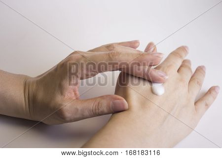 Hands of caucasian woman selfmassage with cream