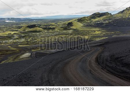Volcanic landscape in Lakagigar with saturated green moss black volcanic sand and craters on Iceland