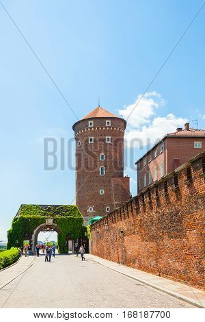 Poland, Krakow - June 09, 2016: Tourists Walking Near The Bernardine Gate And Medieval Sandomierska
