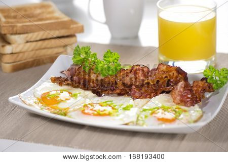 Fried egg with a bacon on the table