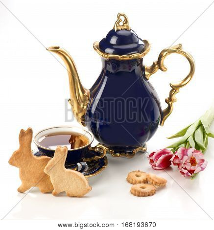 Easter homemade gingerbread cookies and tea cup with flowers on a white background
