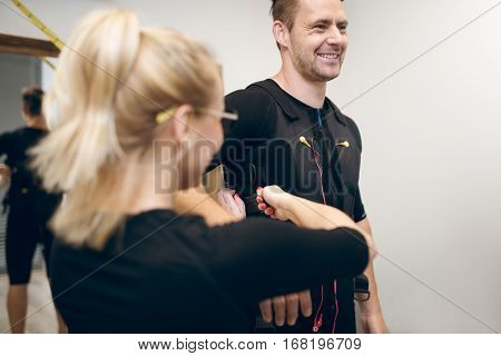 Happy Man In Ems Suit And Woman Helping Him Putting It On