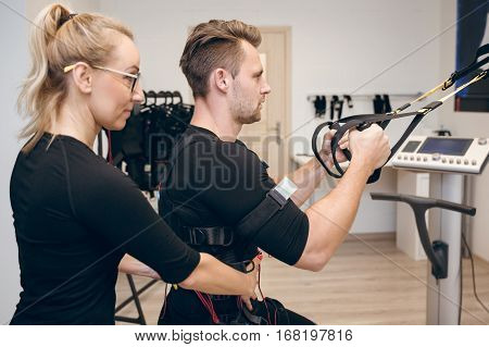 Determined Man Doing Ems Training With His Coach