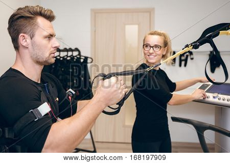 Man Doing Ems Training And His Coach