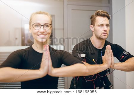 Concentrated Sportsman And Happy Trainer In Yoga Pose