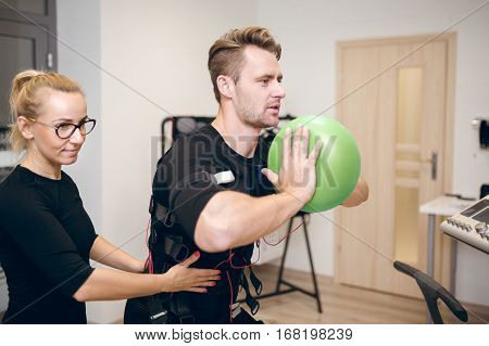 Handsome Sportsman Training With Coach Squeezing Ball