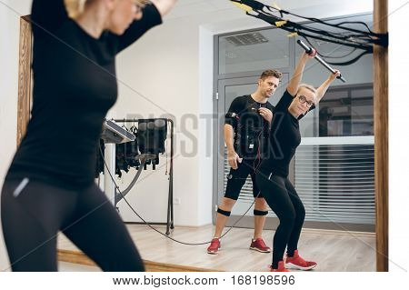 Mirror Reflection Of Female Coach Teaching Sportsman