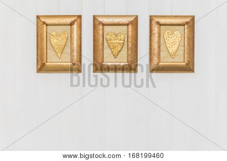 Three Framed Gold Hearts. White Background. Copy Space.