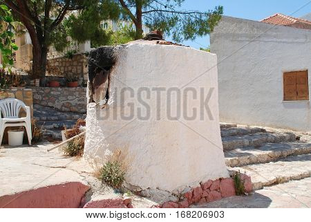 A traditional old stone bread oven in the street at Emborio on the Greek island of Halki.